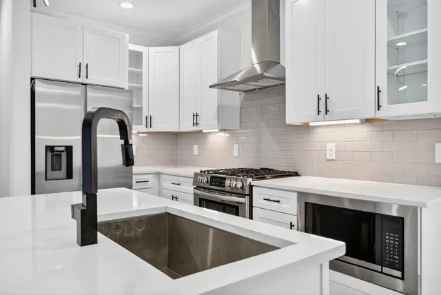 a kitchen with granite countertop a stove and a sink