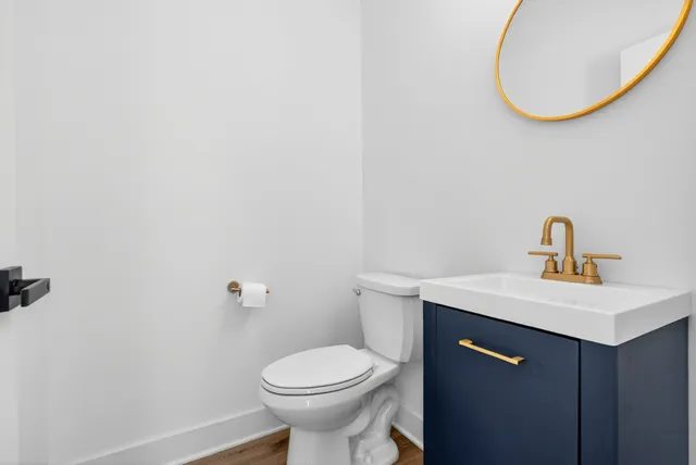 a bathroom with a sink a toilet and a mirror