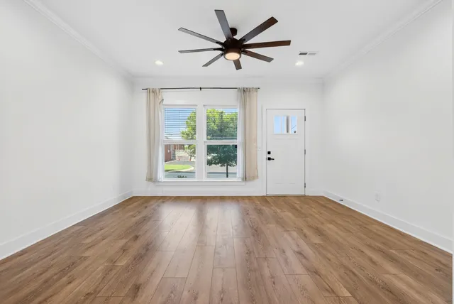 wooden floor in an empty room with a window
