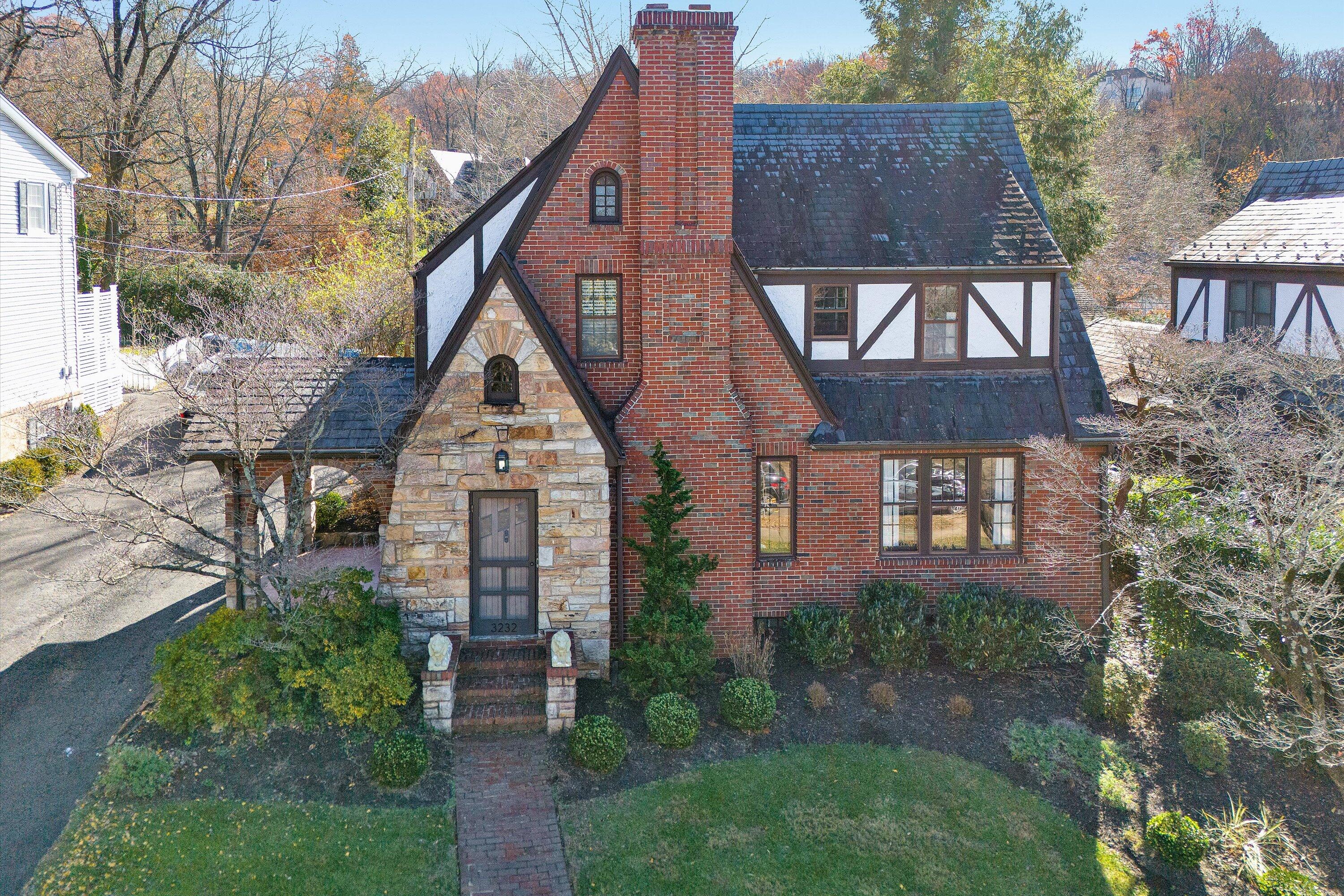 a view of a brick house next to a yard