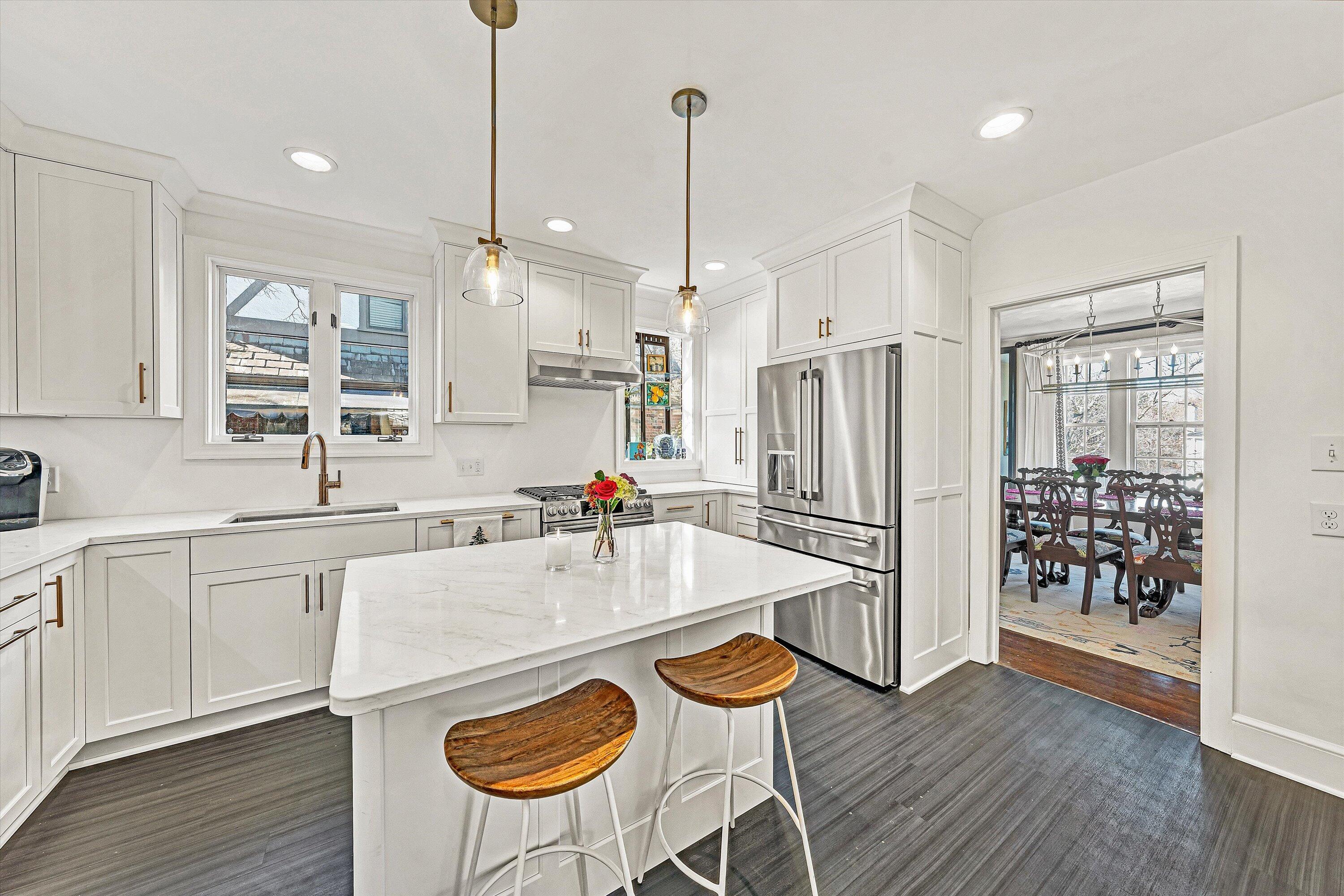3232 Allendale Street Southwest Roanoke, VA 24014 - Photo 14 of 48 a large kitchen with kitchen island a wooden floor and white appliances