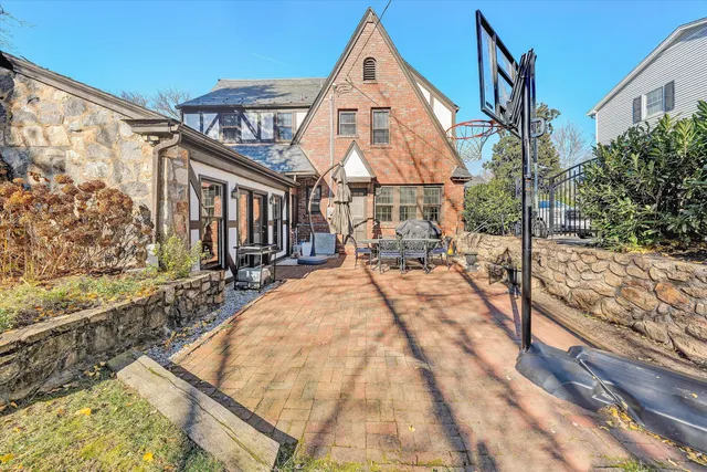 a view of a patio with table and chairs and wooden fence