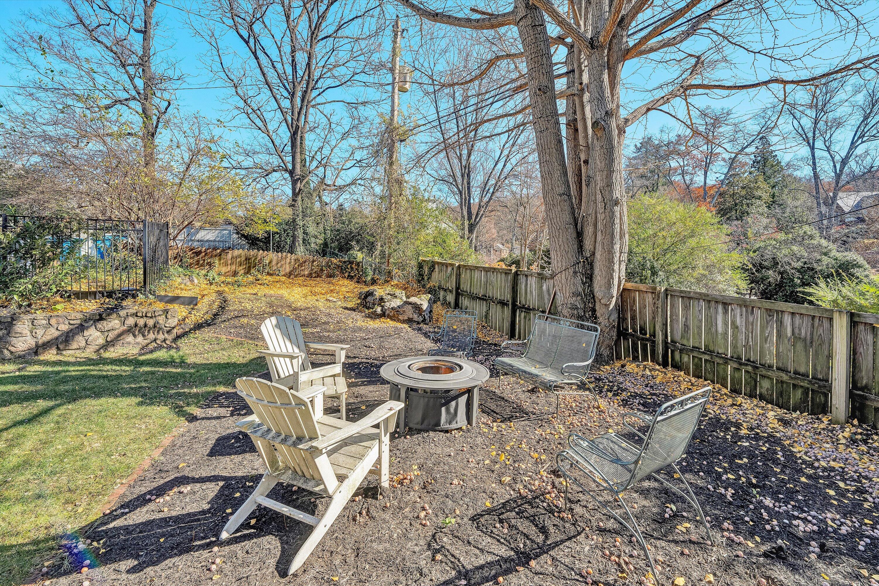 3232 Allendale Street Southwest Roanoke, VA 24014 - Photo 43 of 48 a view of a patio with table and chairs and floor to ceiling window and wooden fence