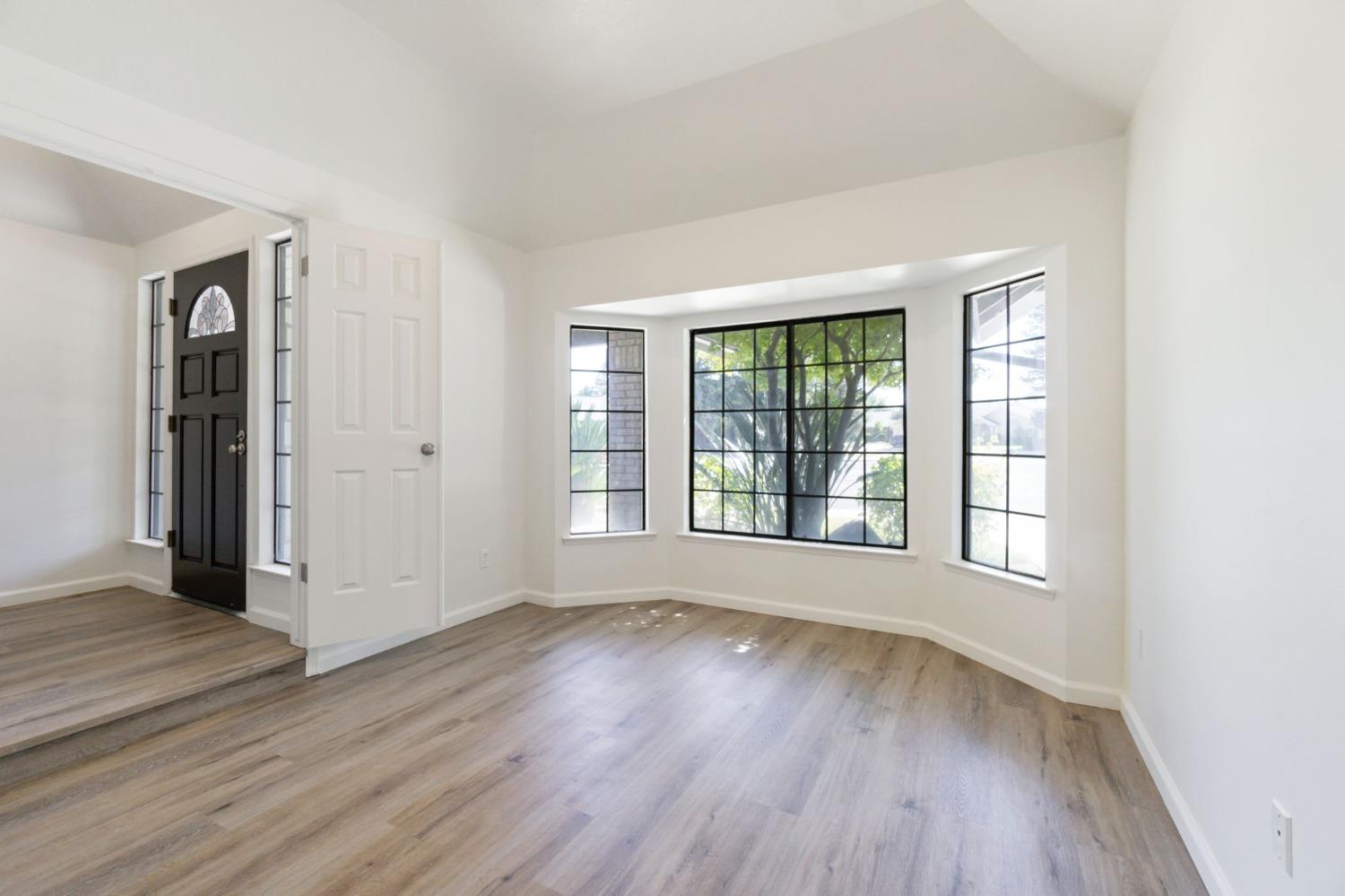 1965 Swift Avenue Clovis, CA 93611 - Photo 25 of 43 an empty room with wooden floor and windows