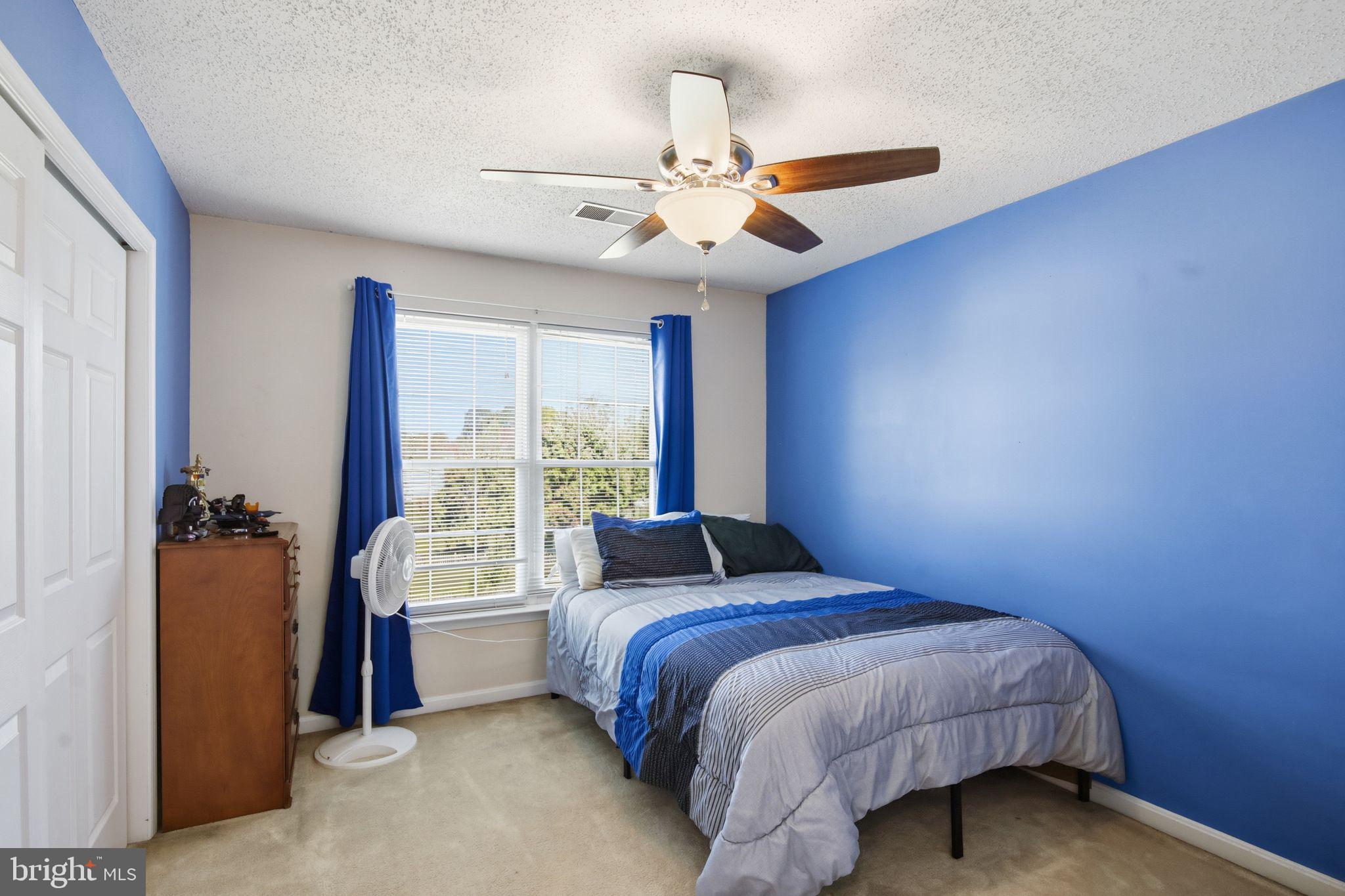 3 Rixey Court Fredericksburg, VA 22405 - Photo 16 of 31 a bedroom with a large bed and a chandelier