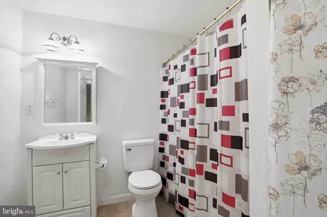 a bathroom with a sink mirror toilet and shower