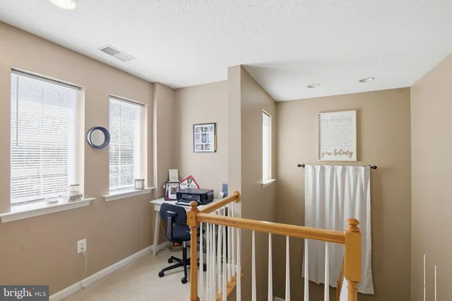 a view of a room with wooden floor and windows