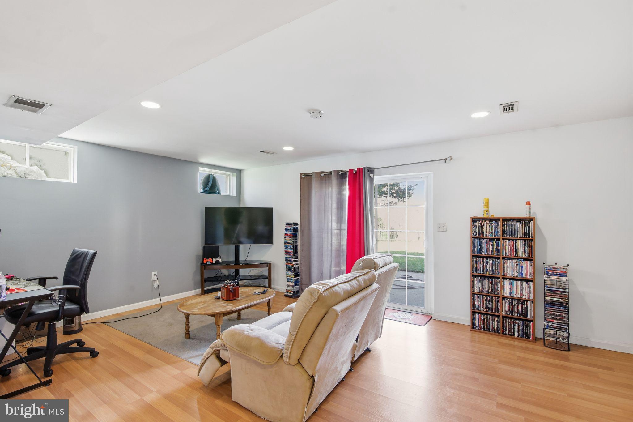 3 Rixey Court Fredericksburg, VA 22405 - Photo 3 of 31 a living room with furniture a flat screen tv and a book shelf