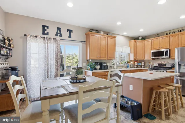 a kitchen with a sink a counter top space appliances and cabinets