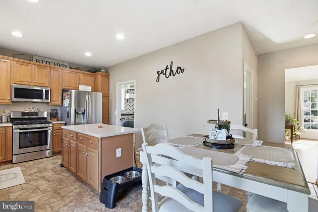 a kitchen that has a lot of cabinets in it and appliances
