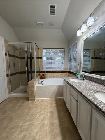 a large bathroom with a large tub shower and sink