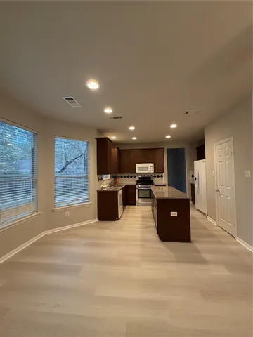 a large room with wooden floor and windows