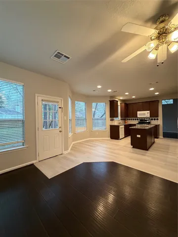 a view of a kitchen with a large counter top and living room