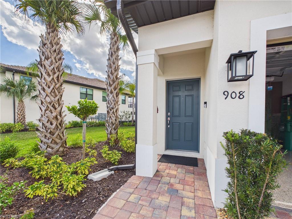 5683 Mayflower Way, Unit 908 Ave Maria, FL 34142 - Photo 36 of 37 Doorway to property with stucco siding
