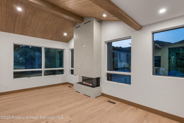 a kitchen with a stove a refrigerator a sink and chairs