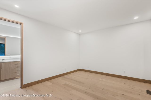 a spacious bathroom with a shower sink double mirror and shower