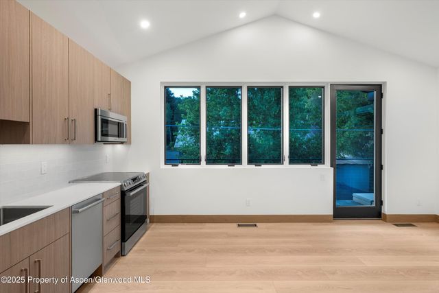 a view of an empty room with large windows