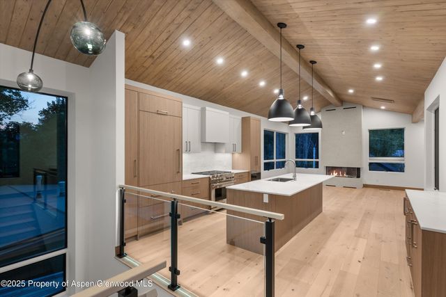 a very nice looking living room with a large window and kitchen view