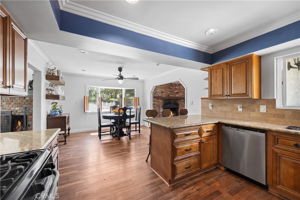 24405 Derian Drive Newhall, CA 91321 - Photo 12 of 36 a kitchen with a sink appliances and wooden floor