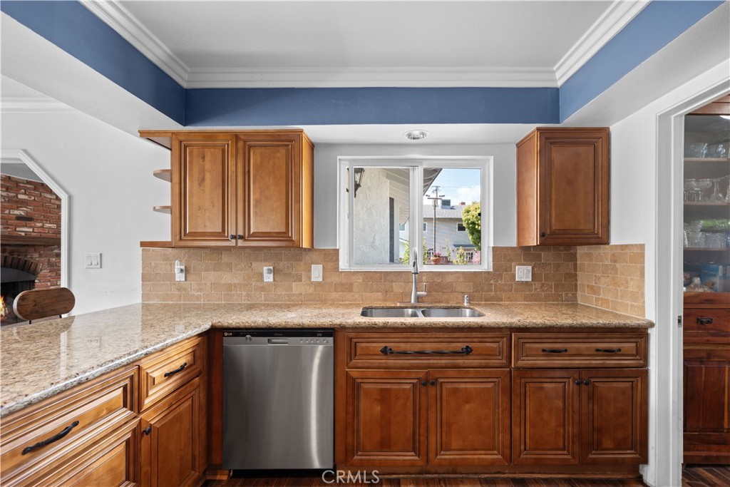 24405 Derian Drive Newhall, CA 91321 - Photo 13 of 36 a kitchen with granite countertop a sink cabinets and stainless steel appliances