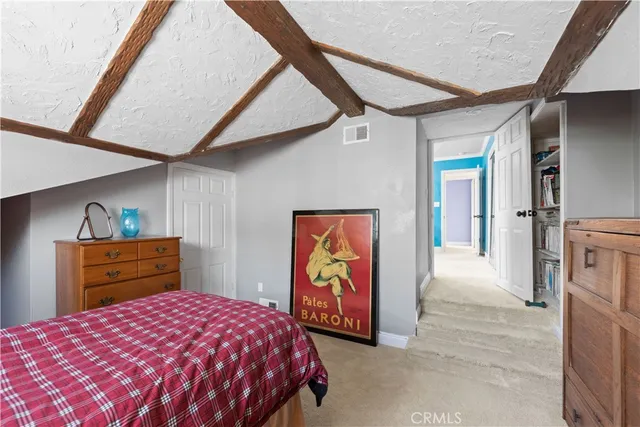 a bedroom with a bed and a dresser