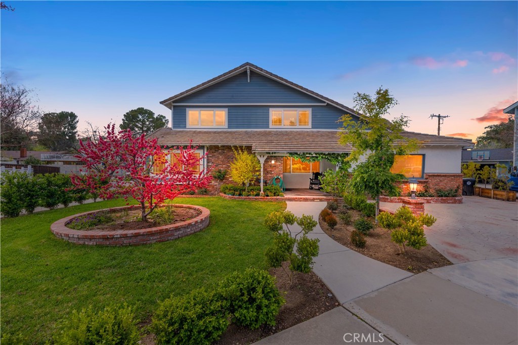 24405 Derian Drive Newhall, CA 91321 - Photo 3 of 36 a front view of a house with a yard