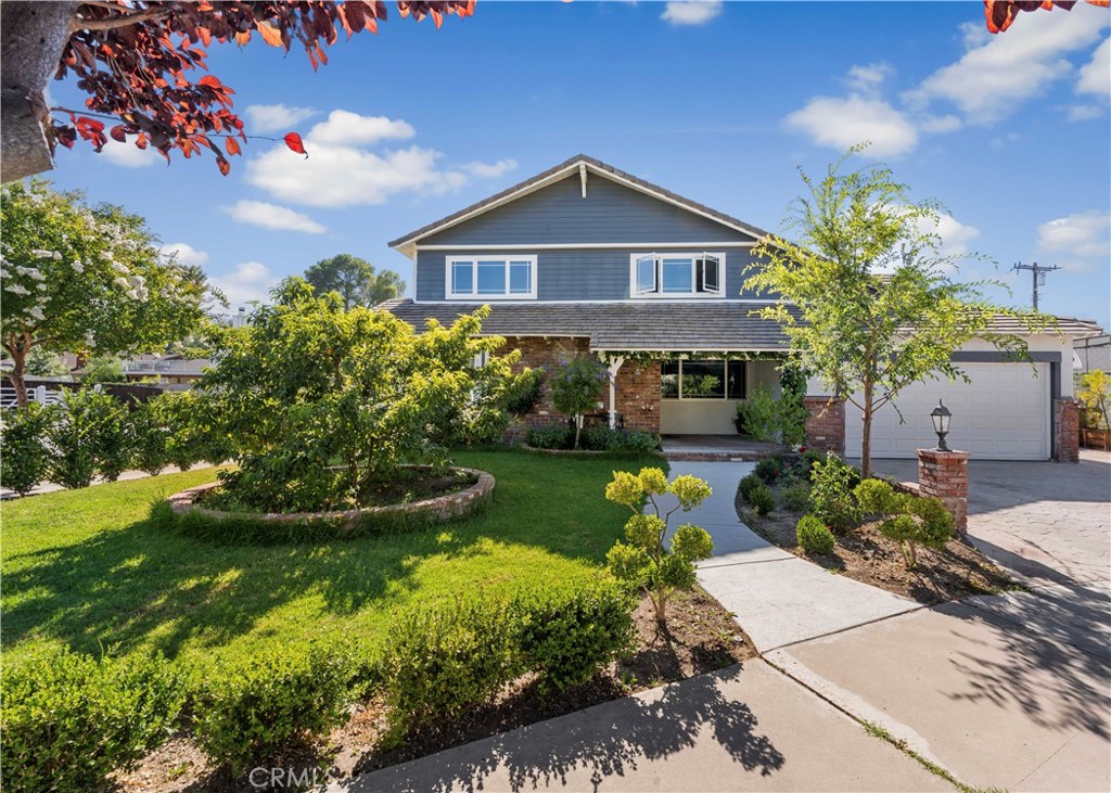 24405 Derian Drive Newhall, CA 91321 - Photo 31 of 36 a front view of a house with a garden