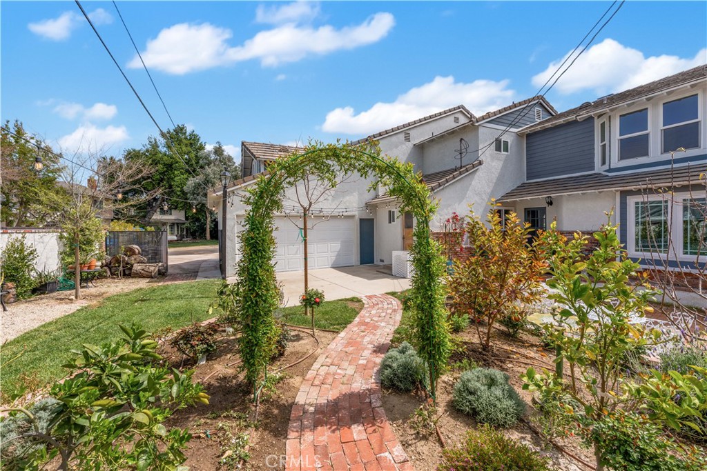 24405 Derian Drive Newhall, CA 91321 - Photo 34 of 36 a front view of a house with garden