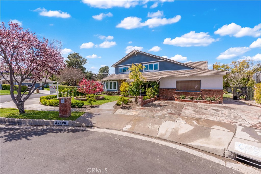 24405 Derian Drive Newhall, CA 91321 - Photo 36 of 36 a front view of a house with a garden and pathway