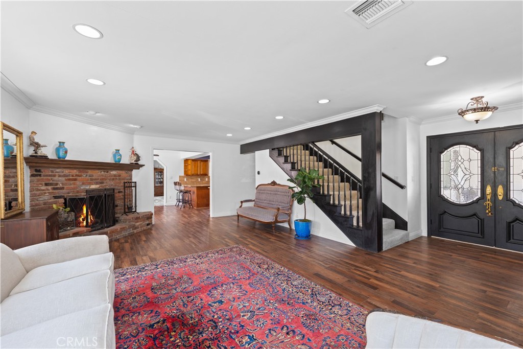 24405 Derian Drive Newhall, CA 91321 - Photo 5 of 36 a living room with fireplace furniture and a wooden floor