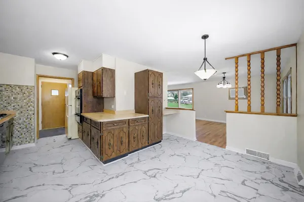 a spacious bathroom with a tub sink and mirror