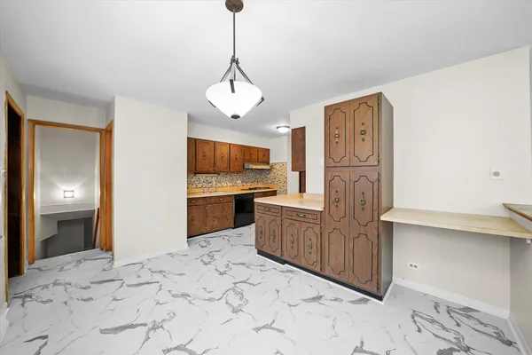 a view of a kitchen with microwave and cabinets