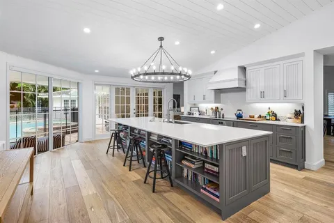 a kitchen with stainless steel appliances granite countertop a lot of counter space and wooden floors