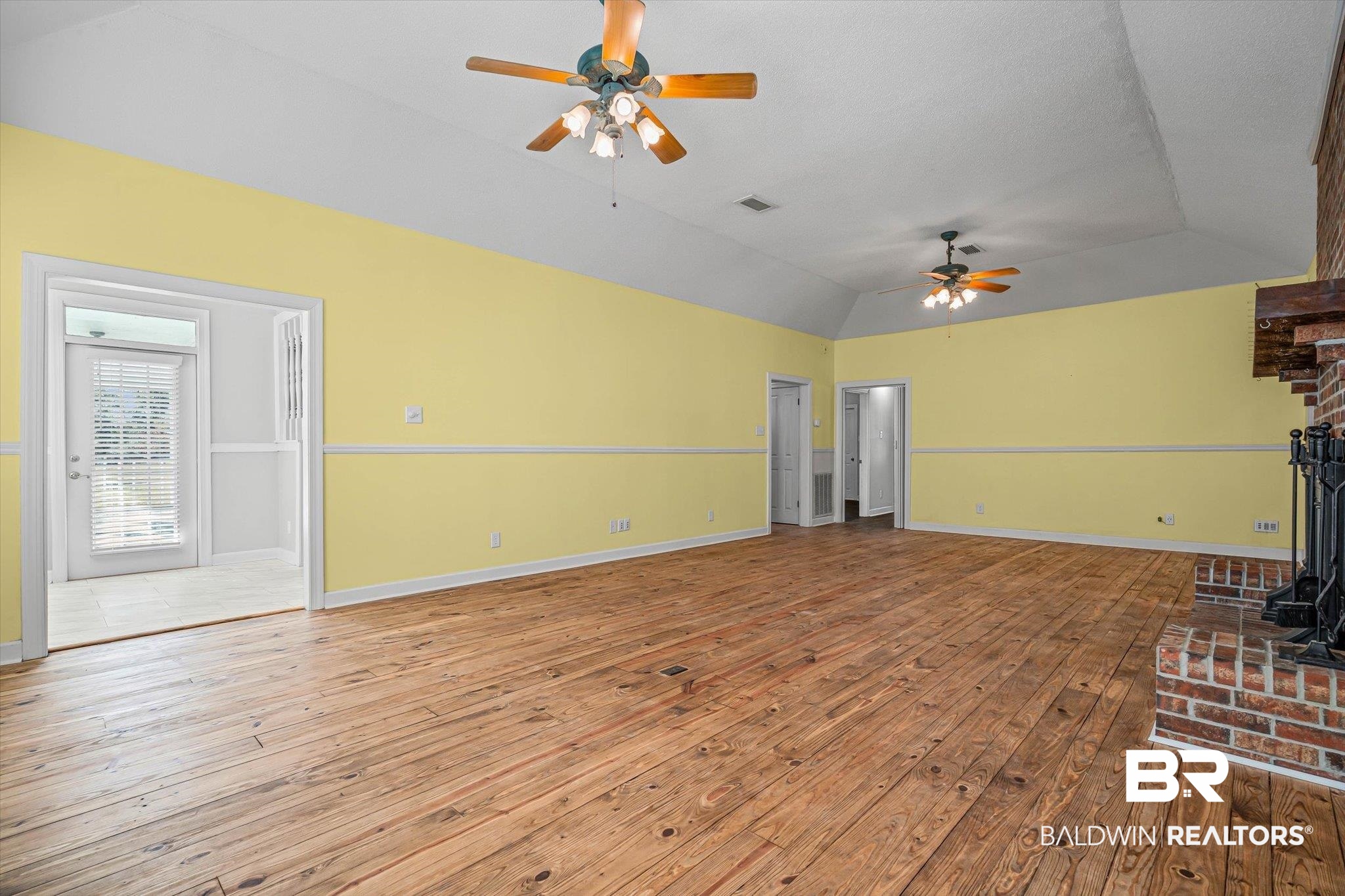 7650 Iron Rush Road Wilmer, AL 36587 - Photo 10 of 34 Unfurnished living room with vaulted ceiling, light wood-type flooring, and ceiling fan