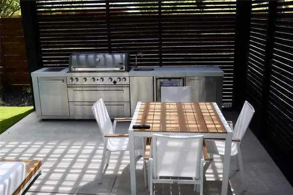 a backyard of a house with table and chairs