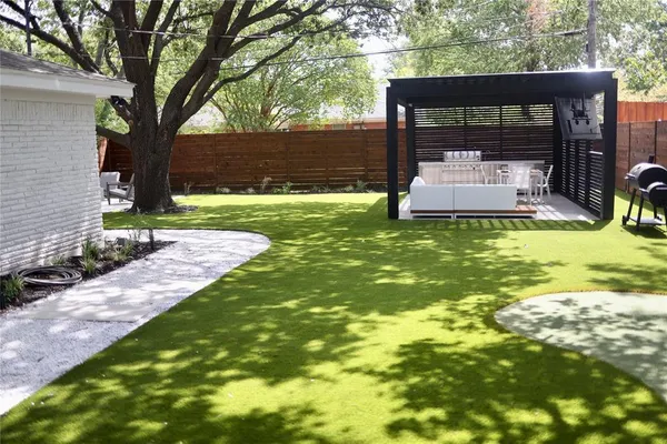 a backyard of a house with table and chairs