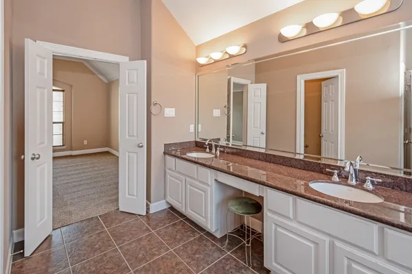 a bathroom with a double vanity sink and a mirror
