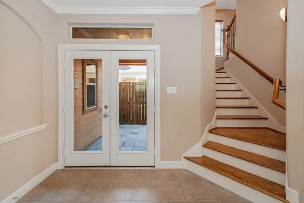 a view of entryway with wooden floor and stairs