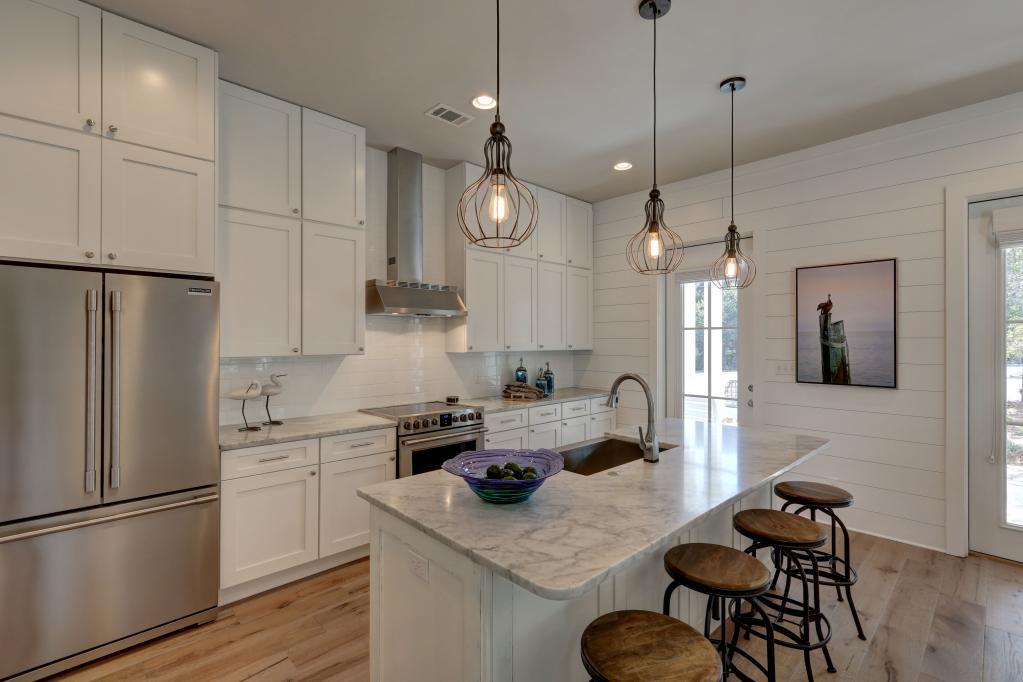 10 Sea Grade Road Santa Rosa Beach, FL 32459 - Photo 18 of 51 a kitchen with a refrigerator a stove a sink and chairs