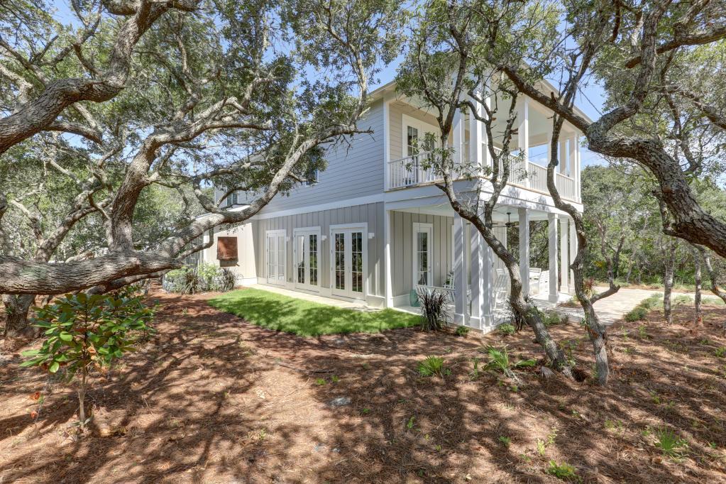 10 Sea Grade Road Santa Rosa Beach, FL 32459 - Photo 3 of 51 a front view of a house with a garden