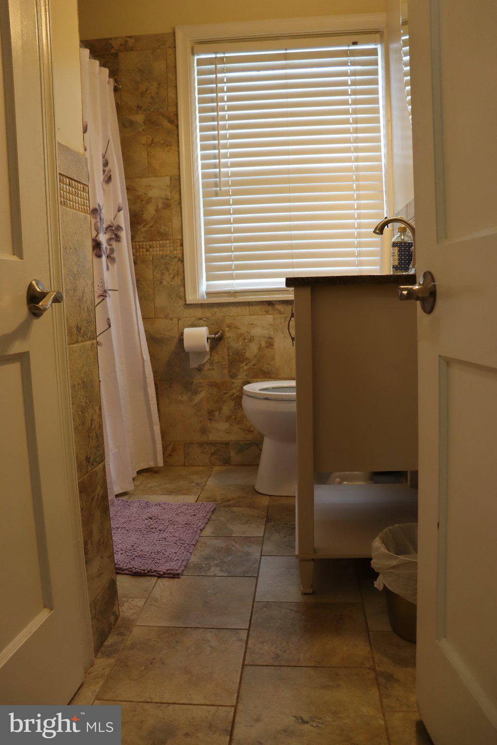 1328 Cedarcroft Road Baltimore, MD 21239 - Photo 20 of 39 Serene bathroom with natural light.