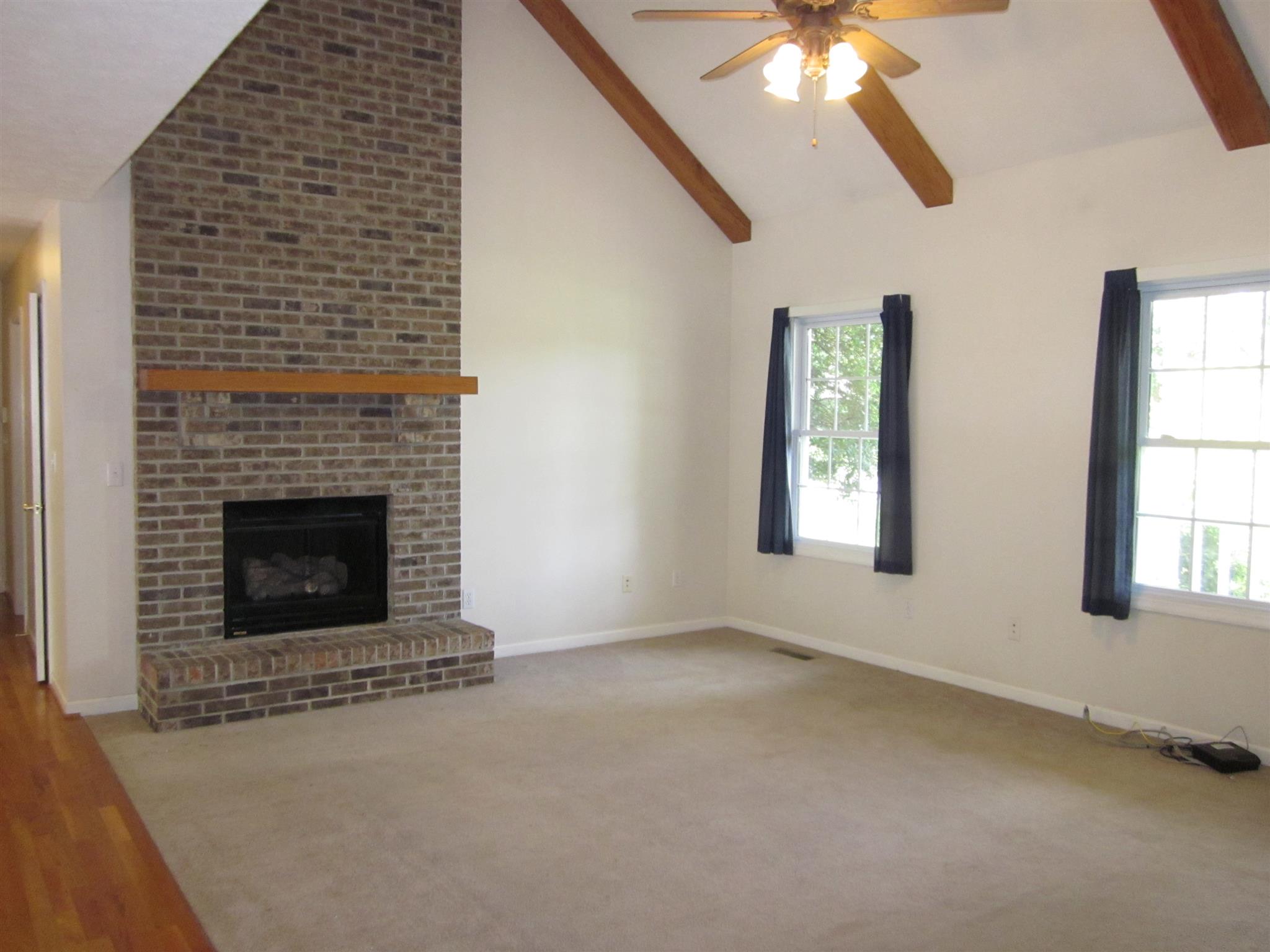 391 Faith-Rae Boulevard Morrison, TN 37357 - Photo 3 of 30 an empty room with a fireplace and windows