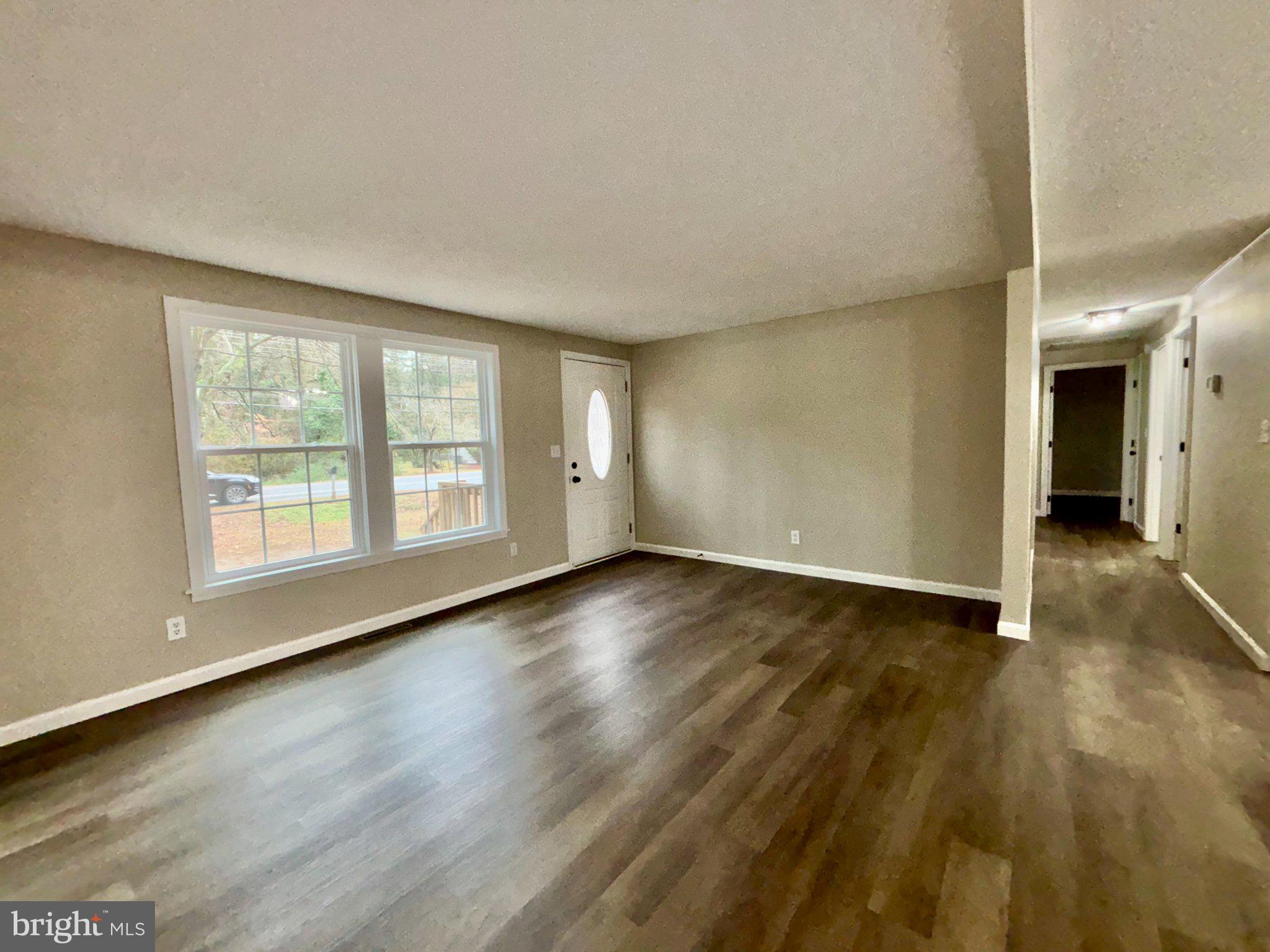 12995 Rousby Hall Road Lusby, MD 20657 - Photo 6 of 16 Spacious, light-filled living area.