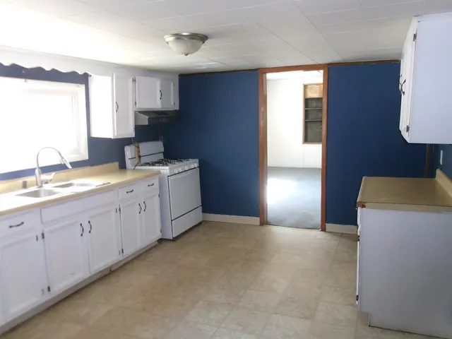 a spacious bedroom with a bed and a cabinets