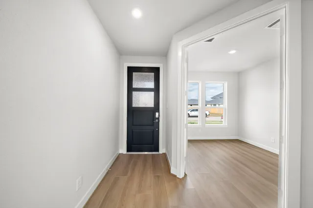 an empty room with windows and closet