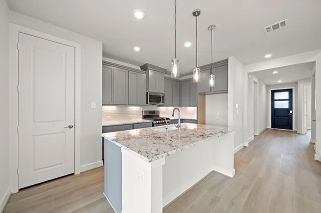 a view of a kitchen counter space with wooden floor
