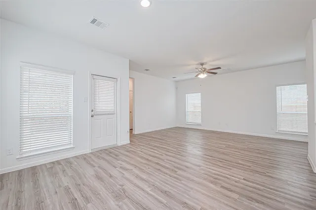 wooden floor in an empty room with a window