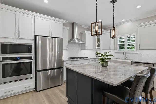 a kitchen with stainless steel appliances granite countertop a sink refrigerator and microwave