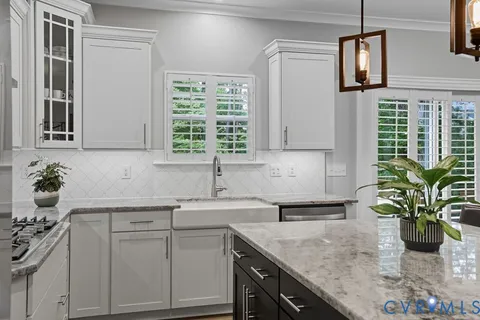 a kitchen with a sink a counter and cabinets