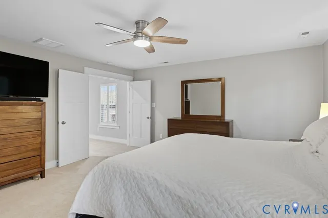 a bedroom with a large bed and a flat screen tv